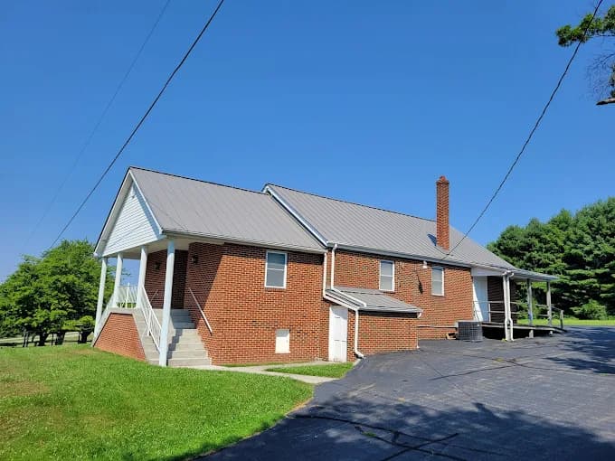 Brick home with a new metal roof and seamless gutters